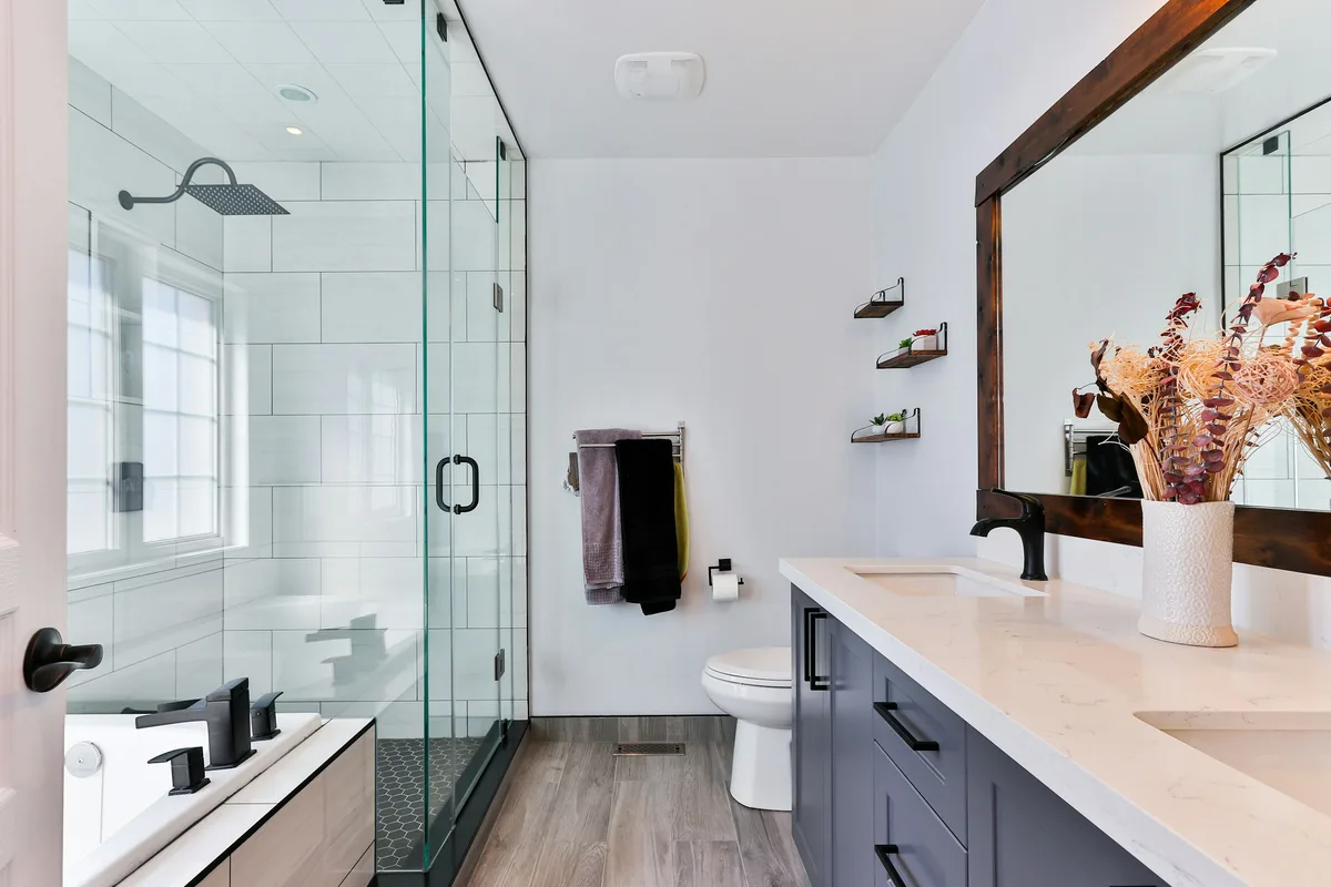 Bright modern bathroom with glass shower and vanity