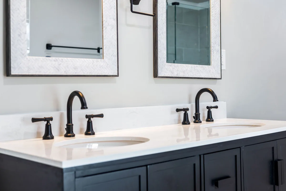 Double-sink bathroom vanity with black faucets